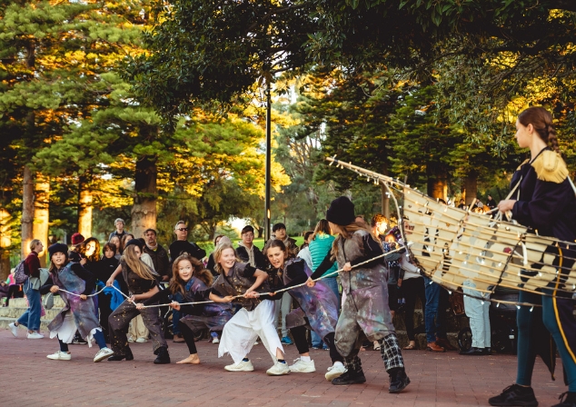 Image of people pulling a boat